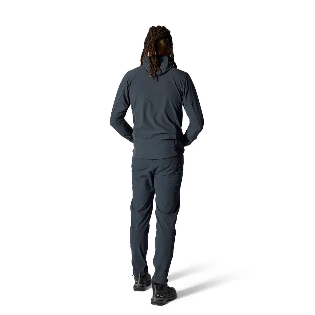 Man wearing dark grey Rab Borealis softshell jacket and trousers hiking